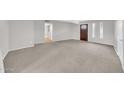 Spacious living room with neutral carpet and ample natural light at 3124 W Port Royale Ln, Phoenix, AZ 85053