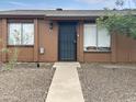 Charming home featuring a secured front door, rock landscaping and cozy covered entrance at 3646 N 67Th Ave # 64, Phoenix, AZ 85033