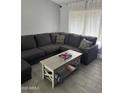Cozy living room features a large sectional couch, accent pillows, and a coffee table at 3646 N 67Th Ave # 64, Phoenix, AZ 85033