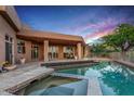 Back of house and pool at dusk, showing outdoor living space at 40858 N 109Th Pl, Scottsdale, AZ 85262