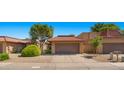 Charming home featuring a red tile roof, desert landscaping, and a two-car garage in a desirable neighborhood at 4346 E Bannock St, Phoenix, AZ 85044