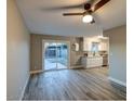 Open-concept living space with modern flooring, slider door, and white cabinets in the kitchen at 5222 N 41St Ave, Phoenix, AZ 85019