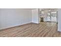 Bright living room featuring sleek wood flooring and access to the kitchen at 5510 E Dallas St, Mesa, AZ 85205