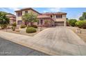 Beautiful home featuring stone accents, a spacious driveway, three-car garage and expertly landscaped surroundings at 5812 W Spur Dr, Phoenix, AZ 85083