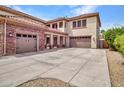 Three car garage with stone accents and plenty of driveway space and an upstairs balcony at 5812 W Spur Dr, Phoenix, AZ 85083