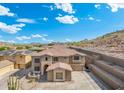 Aerial view of a two-story home with desert landscaping and a neighborhood surrounded by mountains at 6202 W Maya Dr, Phoenix, AZ 85083