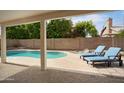 Inviting backyard pool area with comfortable lounge chairs under a covered patio at 6366 W Saint John Ave, Glendale, AZ 85308