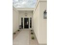 Welcoming front entry featuring a black door, modern lighting, and manicured landscaping at 6529 E Eugie Ter, Scottsdale, AZ 85254
