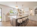 Bright kitchen featuring a large island with seating, custom cabinetry, and stylish pendant lighting at 6529 E Eugie Ter, Scottsdale, AZ 85254