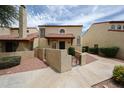Inviting condo with red tile roof, stucco walls, gated courtyard, and tidy landscaping at 6533 N 7Th Ave # 18, Phoenix, AZ 85013