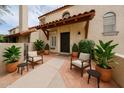 Inviting front entrance with stylish seating area and desert landscaping creates a warm welcome at 6533 N 7Th Ave # 18, Phoenix, AZ 85013