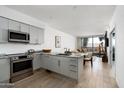 Contemporary kitchen featuring granite countertops, stainless steel appliances, and wood floors at 7180 E Kierland Blvd # 814, Scottsdale, AZ 85254