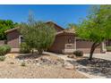Inviting single-story home with desert landscaping and a spacious driveway at 7456 W Irma Ln, Glendale, AZ 85308