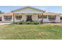 Charming home featuring a well-manicured lawn, flower beds, shutters, and a covered front porch at 7607 N 17Th Ave, Phoenix, AZ 85021