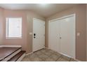 Inviting entryway featuring tile flooring, white doors and staircase, bathed in natural light at 822 E Ross Ave, Phoenix, AZ 85024