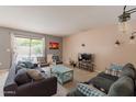 Bright living room featuring dual sofas, accent chairs, sliding doors to the backyard, and stylish decor at 822 E Ross Ave, Phoenix, AZ 85024
