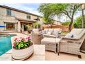 Lounge in this backyard oasis with fire pit, outdoor seating, and a patio at 9034 W Eagle Talon Dr, Peoria, AZ 85383