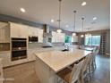 Bright, modern kitchen with an island, stainless steel appliances, and ample counter space at 9187 W Parkside Ln, Peoria, AZ 85383