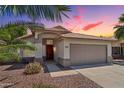 Charming single-story home featuring desert landscaping, a tile roof, and a spacious two-car garage at 1057 W Laurel Ave, Gilbert, AZ 85233