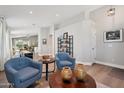 Bright and open living room with neutral tones and modern decor, leading to a game area and dining space at 1057 W Laurel Ave, Gilbert, AZ 85233