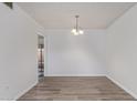 Clean, empty dining room with stylish flooring, light fixture, and doorway access at 11149 W Palm Ridge Dr, Sun City, AZ 85351