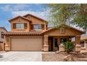 Inviting two-story home with a neutral palette, desert landscaping, covered porch, and a two-car garage at 136 W Brahman Blvd, San Tan Valley, AZ 85143