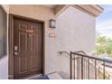 Exterior view of the front door with a 'no smoking' sign, unit number, and railings at 1941 S Pierpont Dr # 2073, Mesa, AZ 85206