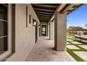 Covered patio with travertine flooring, decorative lights, and outdoor seating, perfect for entertaining at 20055 N 96Th Way, Scottsdale, AZ 85255