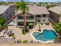 Aerial view of a backyard featuring a pool, spa, outdoor kitchen, patio and lounge seating at 21841 N Ingram Ct, Maricopa, AZ 85138