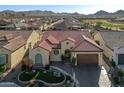 Expansive aerial view captures the tile roof, desert landscaping, and golf course community surrounding this charming single-story home at 25971 W Taro Dr, Buckeye, AZ 85396