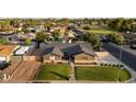 An aerial shot reveals a well-maintained home with a lush lawn, complemented by surrounding greenery at 2619 E Jerome Ave, Mesa, AZ 85204