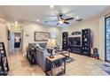 Cozy living room featuring a sectional sofa, tile flooring, and entertainment center at 2801 N Litchfield Rd # 65, Goodyear, AZ 85395