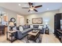 Inviting living room with tile floors, plush gray sectional, and stylish decor at 2801 N Litchfield Rd # 65, Goodyear, AZ 85395