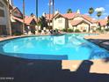 Expansive community pool reflecting the surrounding architecture, inviting residents for a swim at 2801 N Litchfield Rd # 65, Goodyear, AZ 85395