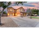 Spacious two-story home featuring a manicured lawn, dual garages, and a basketball hoop for outdoor enjoyment at 2986 E Country Shadows St, Gilbert, AZ 85298