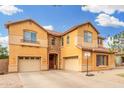 Attractive two-story home showcasing a stone facade, multiple garage doors, and a welcoming entrance at 2986 E Country Shadows St, Gilbert, AZ 85298