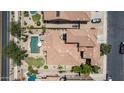 Aerial view of a home with a pool, patio, and well-maintained landscaping in a residential neighborhood at 3441 S Halsted Pl, Chandler, AZ 85286