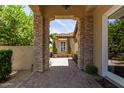 Charming front entry with stone pillars, brick pavers, and lush greenery creating a welcoming path at 3441 S Halsted Pl, Chandler, AZ 85286