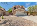 Beautiful two-story home with a well-manicured gravel front yard and a three-car garage at 3750 S Ashley Pl, Chandler, AZ 85286