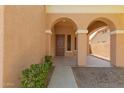 Inviting front porch with arched entryways and manicured landscaping, welcoming you home at 3750 S Ashley Pl, Chandler, AZ 85286