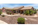 Charming single-story home featuring desert landscaping with an American flag waving in the front at 3930 E Colonial Dr, Chandler, AZ 85249