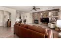 Cozy living room featuring a stone fireplace, comfortable seating and tile floors at 3930 E Colonial Dr, Chandler, AZ 85249