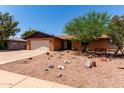 Inviting single-story brick home with drought-resistant landscaping and an attached garage at 4420 E Covina St, Mesa, AZ 85205