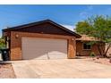 Close up of the attached single car garage and drought resistant landscaping at 4420 E Covina St, Mesa, AZ 85205