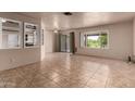 Bright living room with tile floors, windows, and sliding glass door at 4420 E Covina St, Mesa, AZ 85205