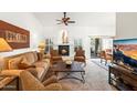 Cozy living room featuring a fireplace, comfortable seating, and seamless access to the outdoor patio and dining area at 4748 E Eden Dr, Cave Creek, AZ 85331