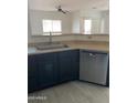 Kitchen with stainless steel dishwasher and sink with breakfast bar to living area at 525 N Miller Rd # 239, Scottsdale, AZ 85257
