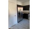Kitchen features a stainless steel refrigerator and dark wood cabinetry at 525 N Miller Rd # 239, Scottsdale, AZ 85257