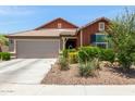Charming single-story home with a well-maintained front yard and attached two-car garage at 652 E Rojo Way, Gilbert, AZ 85297