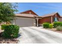 Single-story home featuring a 2-car garage, neutral color palette and tidy landscape in front at 652 E Rojo Way, Gilbert, AZ 85297